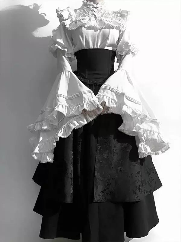 Creamy black-and-white blouse and skirt set with white ruffled sleeves and layered black skirt