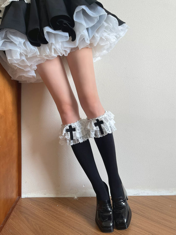 Black slouch socks with white ruffled cuffs and cross details