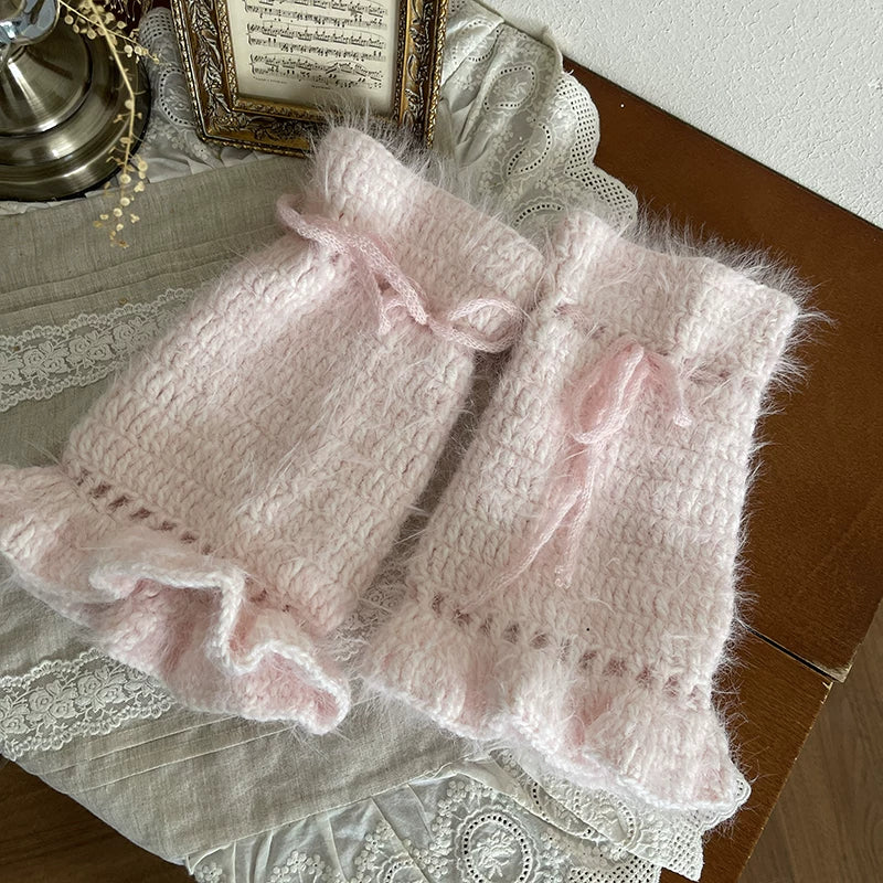 Pink fuzzy sock covers with a scrunched leg line and ribbon ties styled with white platform shoes.