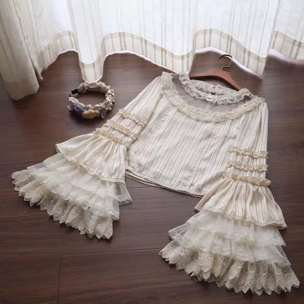 Natural-colour vertically striped blouse with lace collar and layered sleeves laid flat.