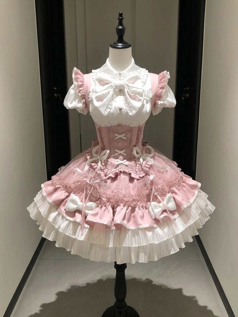White and pink Lolita blouse and bustier skirt set with large bows and layered ruffles
