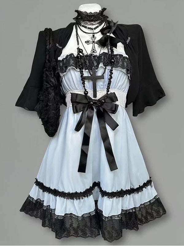 Pale blue and white ruffled dress with short black cardigan and lace trim on a mannequin.