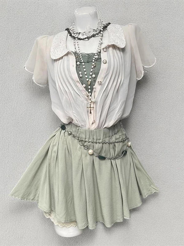 Apricot cardigan and green skirt three-piece set on a mannequin