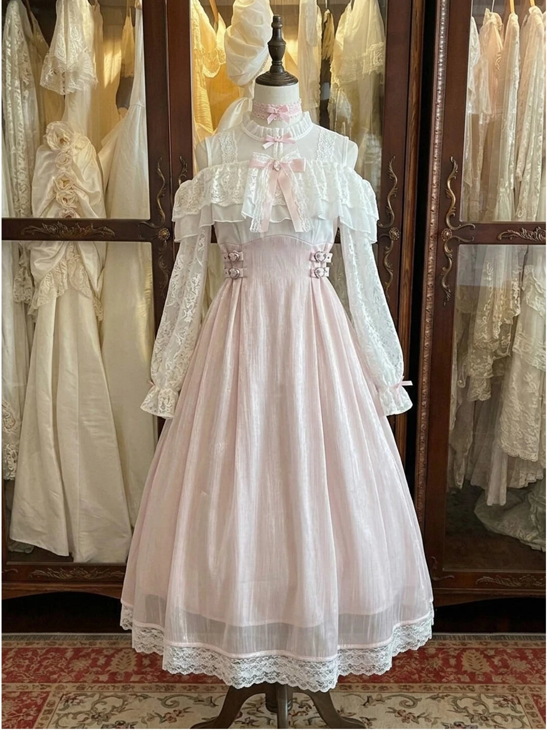 Pale pink full-length long-sleeve OP dress with white lace ruffles and ribbon details