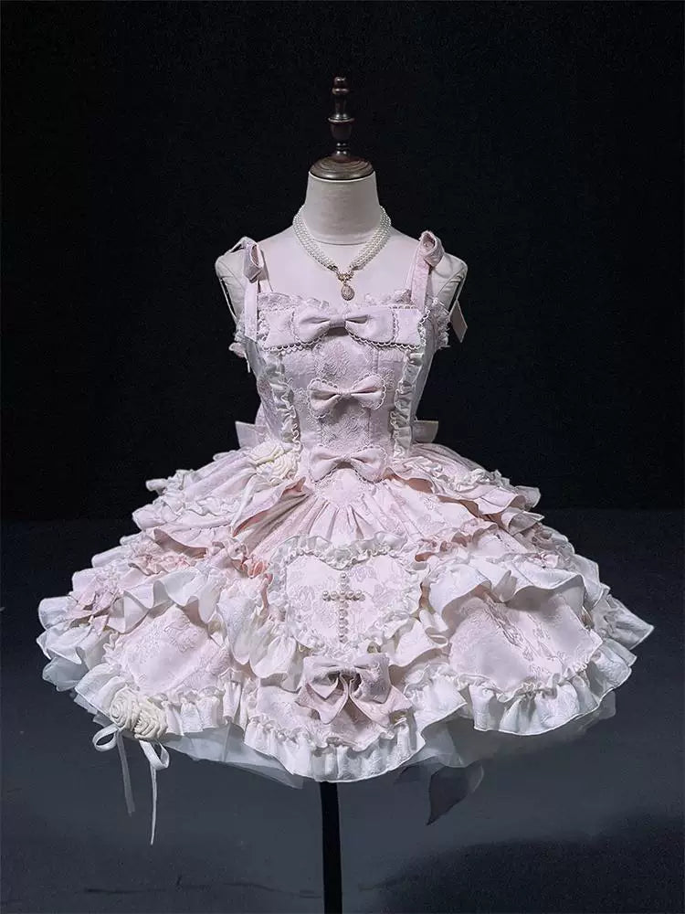 Creamy pink strap-style JSK with layered lace ruffles and bows on a mannequin