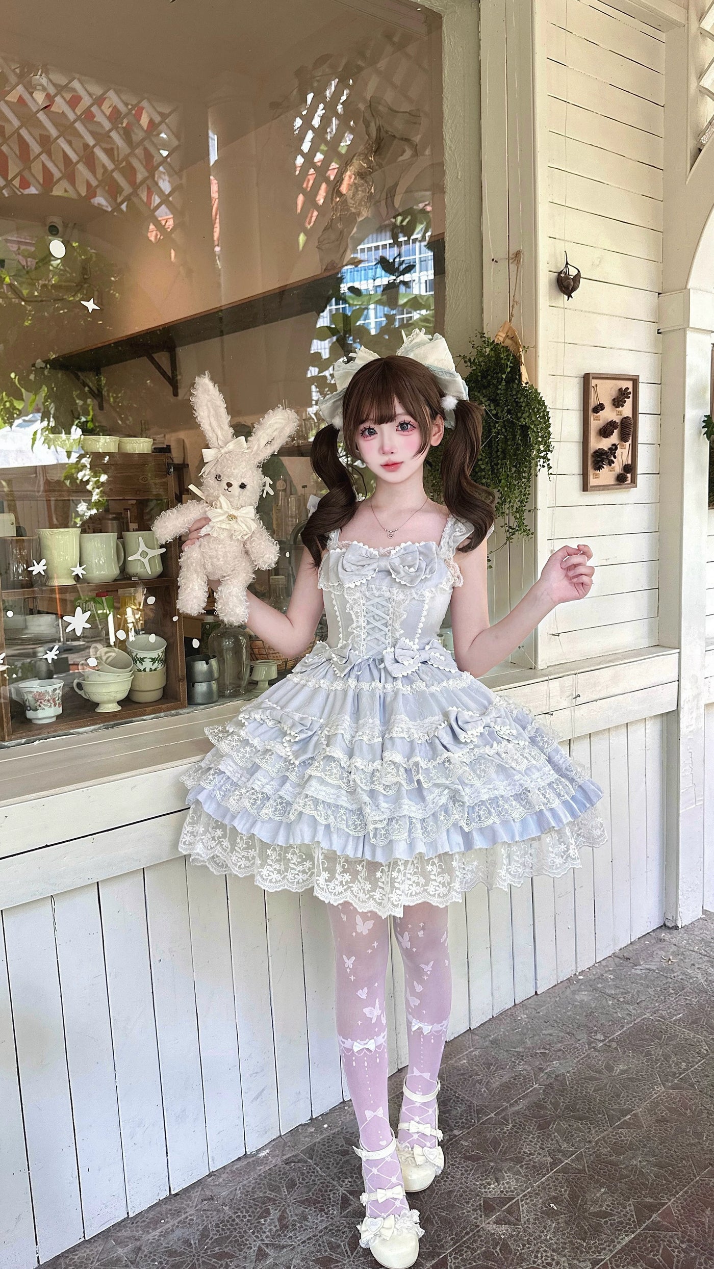 Close-up of Sea Salt Guava YoYo JSK showing lace trim and small fabric bows on skirt tiers