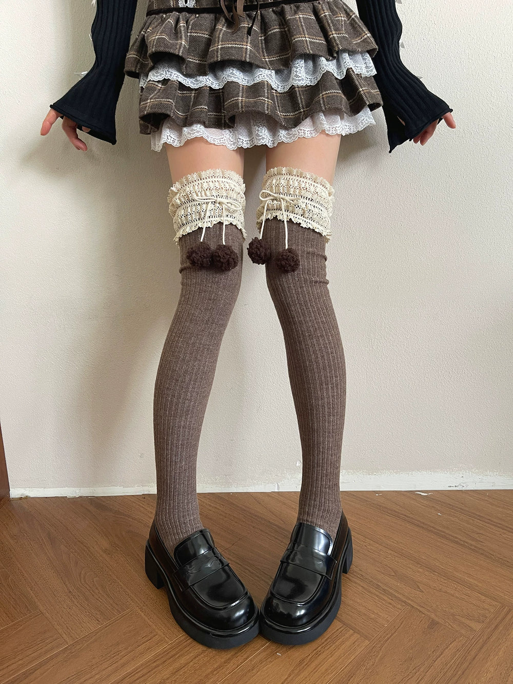 Brown over-the-knee socks with lace cuffs and a ribbed knit texture