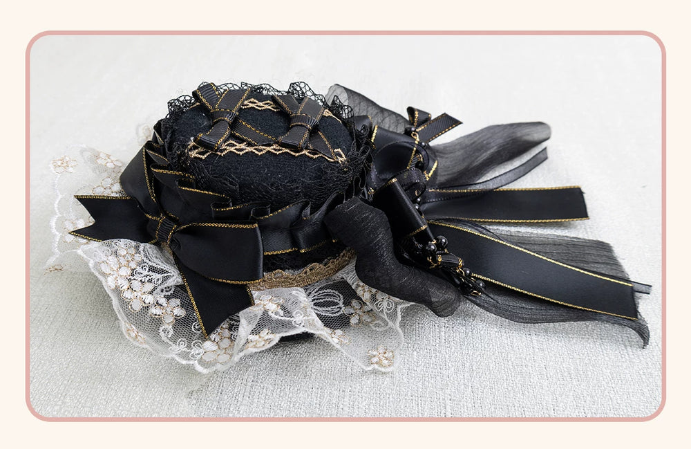 Black headwear with gold-edged bows, lace and bead accents