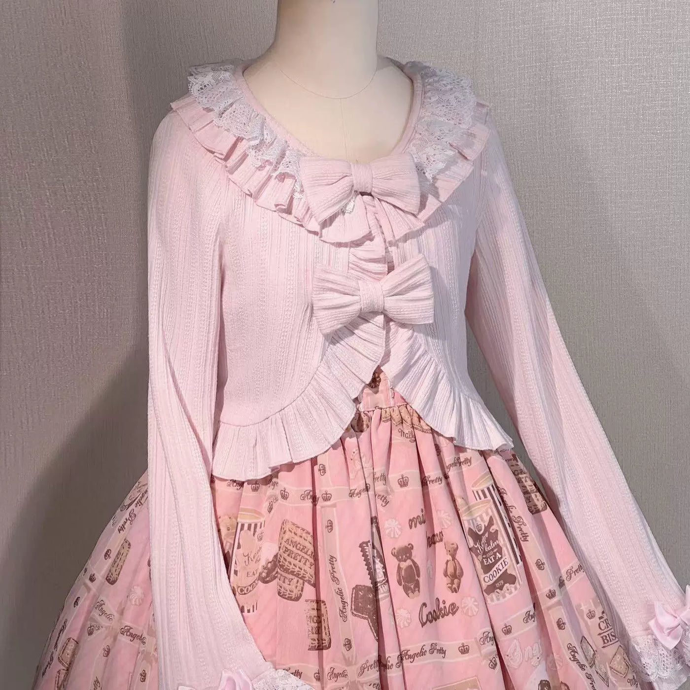 Short ruffled shawl coat shown in pink and pale blue.