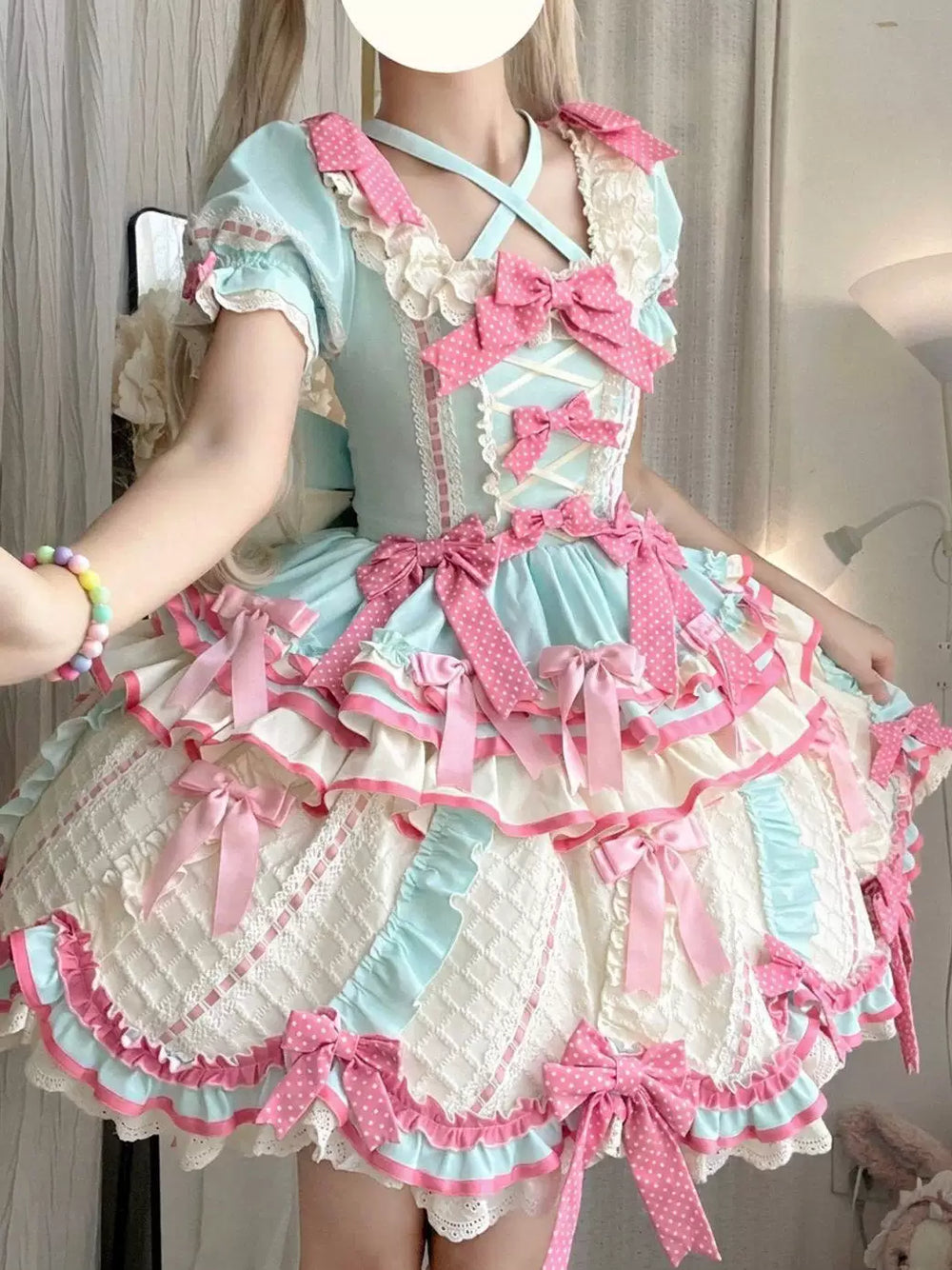 Creamy mint-and-white OP dress with pink bows and lace-trimmed tiers.