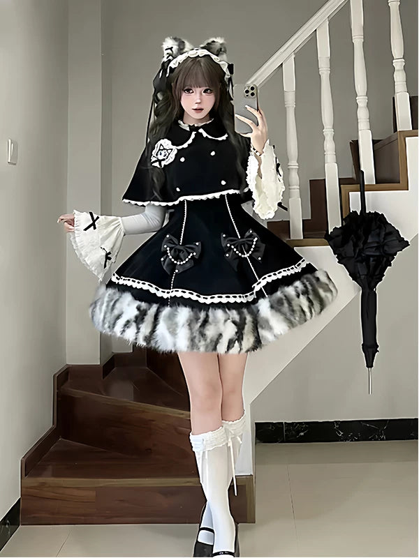 Black and white three-piece JSK set with white lace trim and cape styled on a model