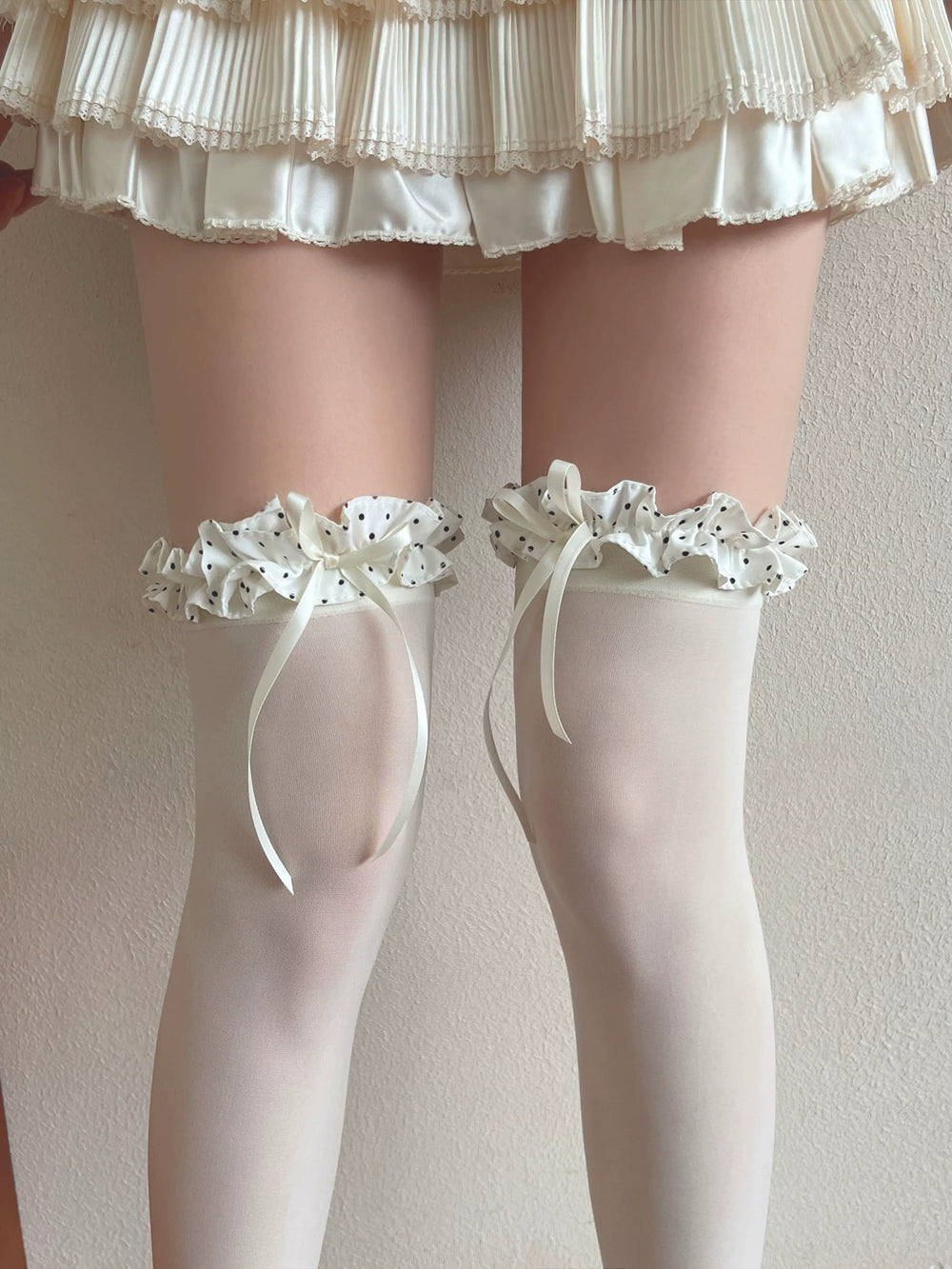 White velvet over-the-knee socks with polka-dot ruffled cuffs and long ribbon ties.