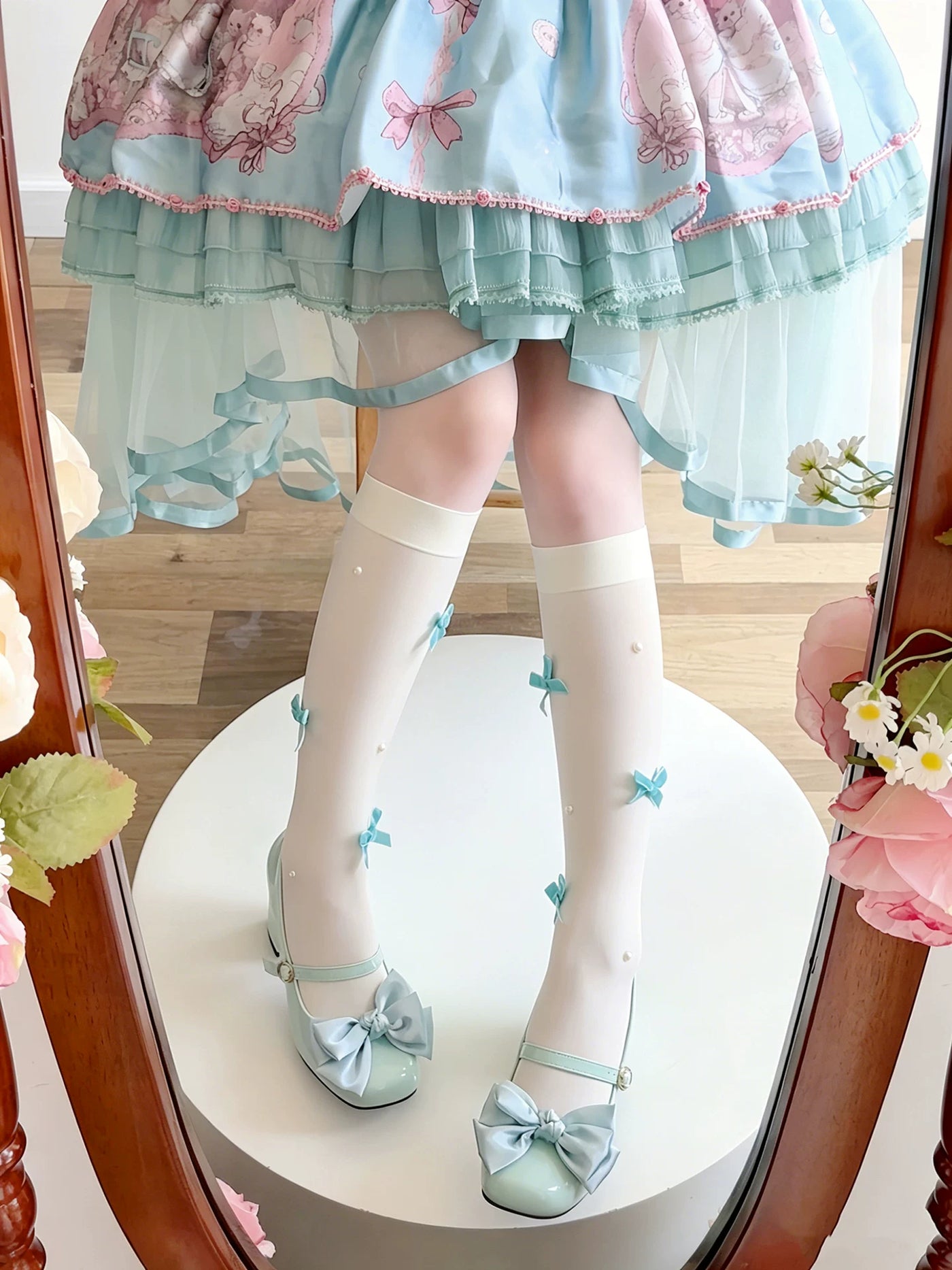 Milky white slouch socks with blue bow details worn with a Lolita coordinate