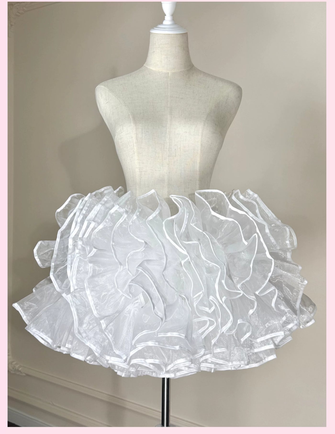 White layered bell-shaped petticoat displayed on a mannequin