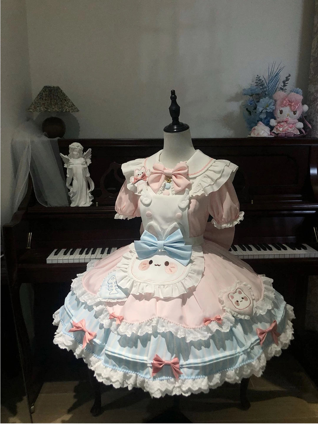 Blue-and-pink ruffled OP dress with a large blue bow on a mannequin