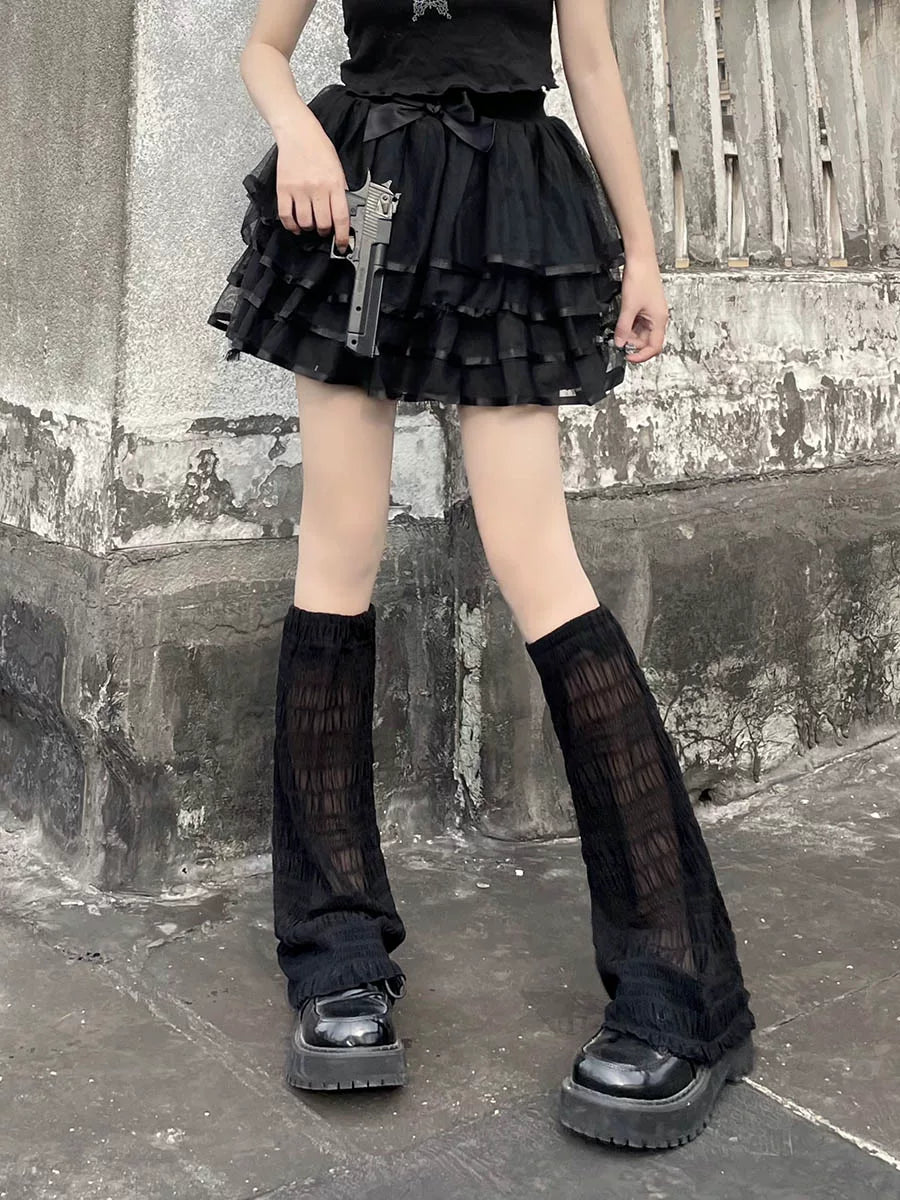 Black sheer gauze footless leg covers styled with platform shoes on a model