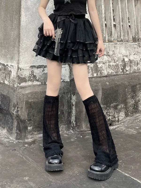 Black sheer gauze footless leg covers styled with platform shoes on a model