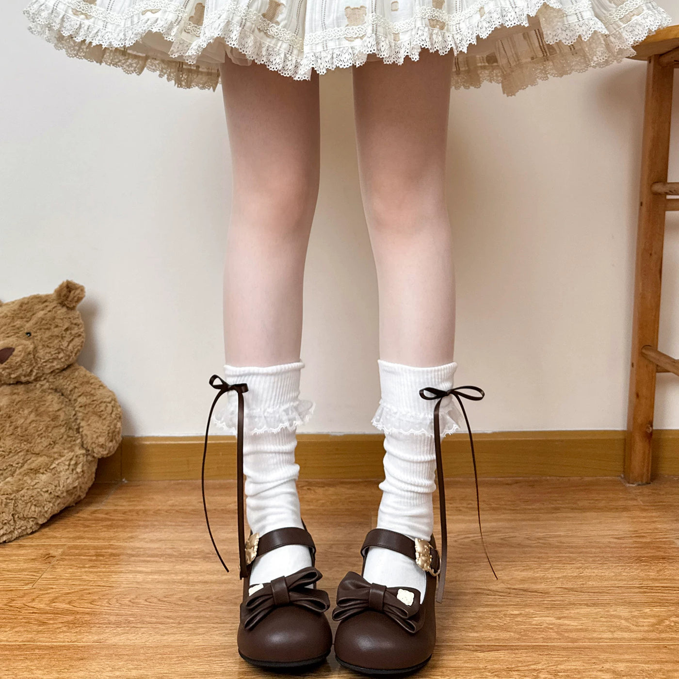 Chubby Bear Tales white calf socks with lace trim and pink ribbon bows worn with pink Mary Jane shoes.