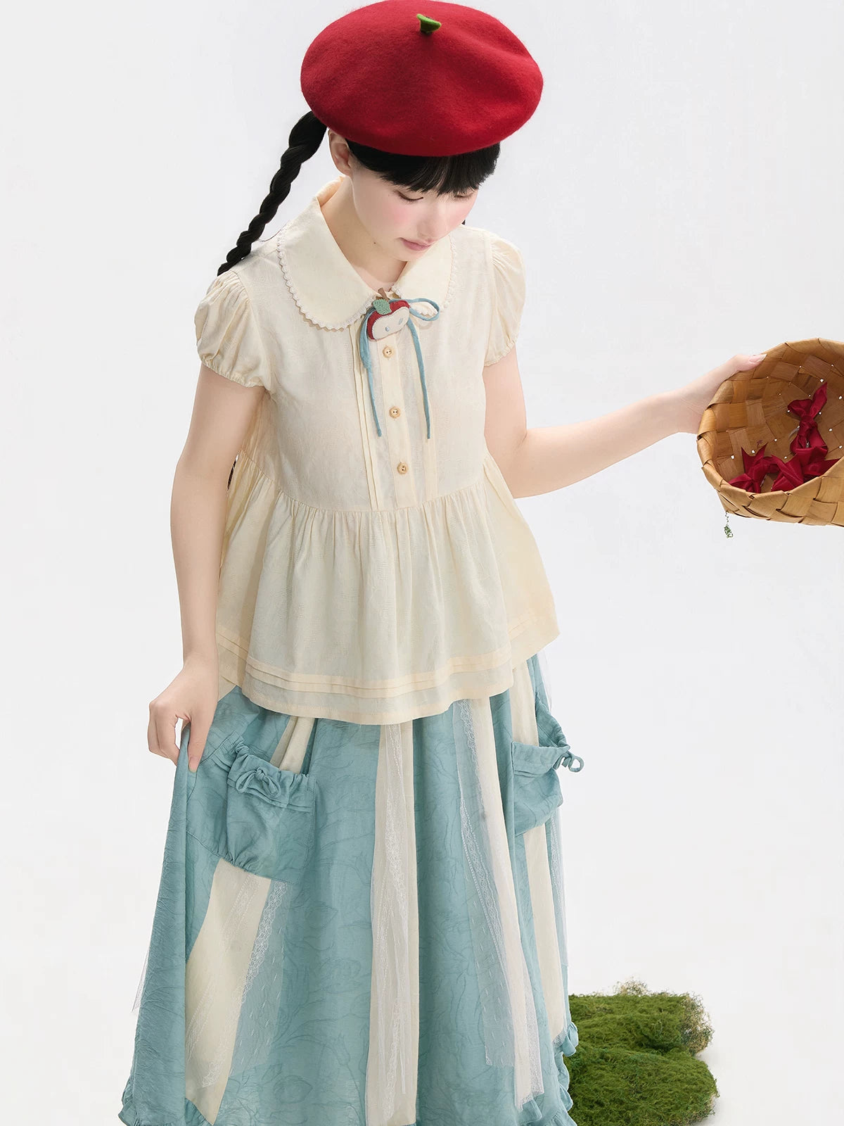 Ivory short-sleeve blouse with a scalloped Peter Pan collar and gathered lower panel.