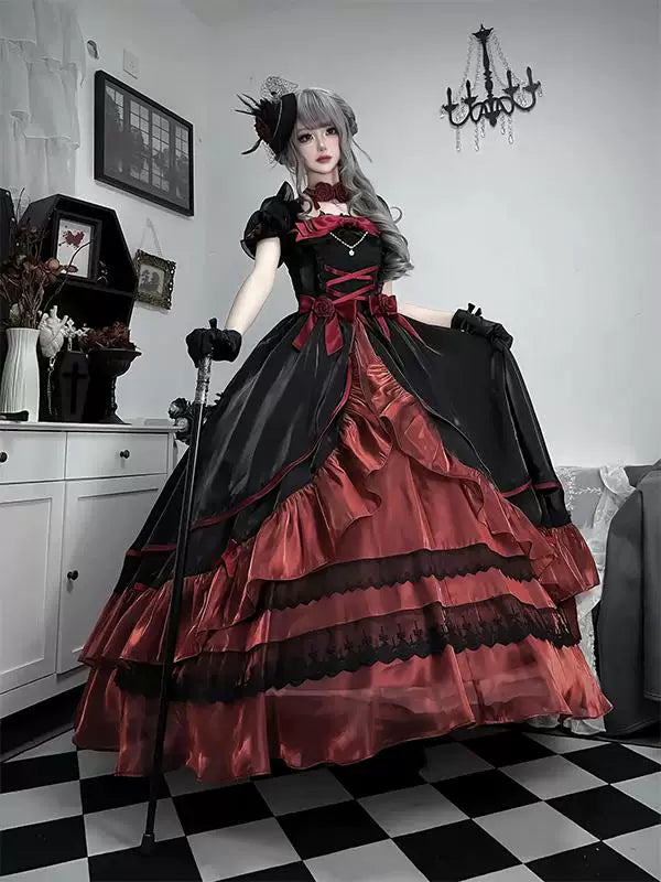 Model wearing a black-and-red OP dress with layered ruffles and a train.