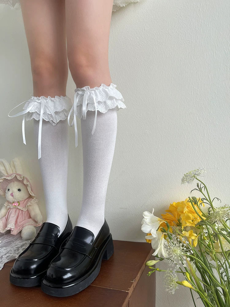 White lace mid-calf socks with bows shown with black shoes