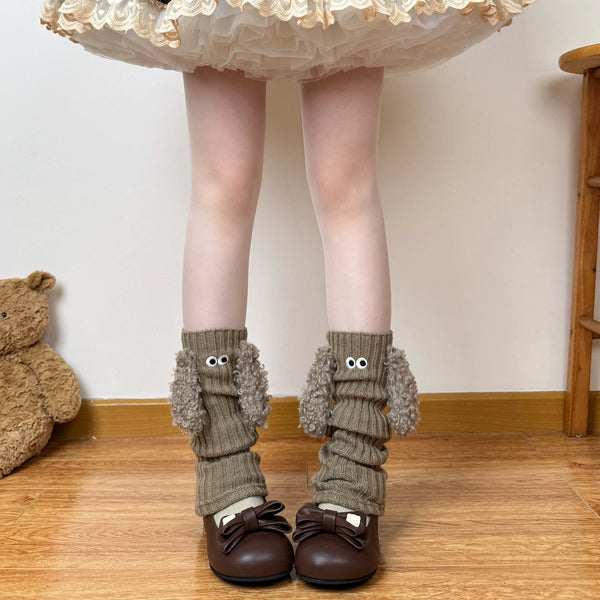 Off-white puppy-inspired ribbed leg warmers with round eye details and plush trim