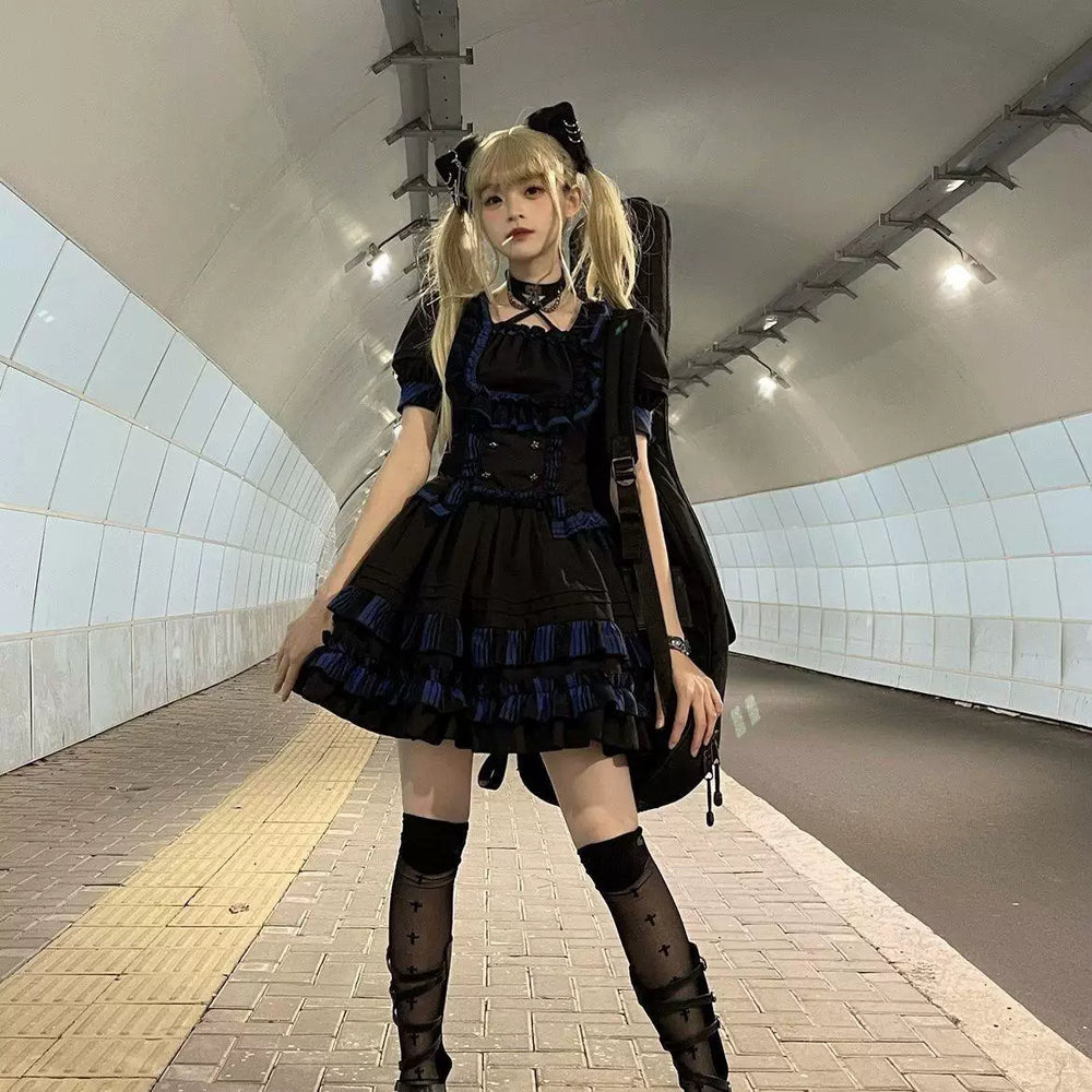 Two models wearing black punk Lolita two-piece dress sets with red and blue contrast trim.