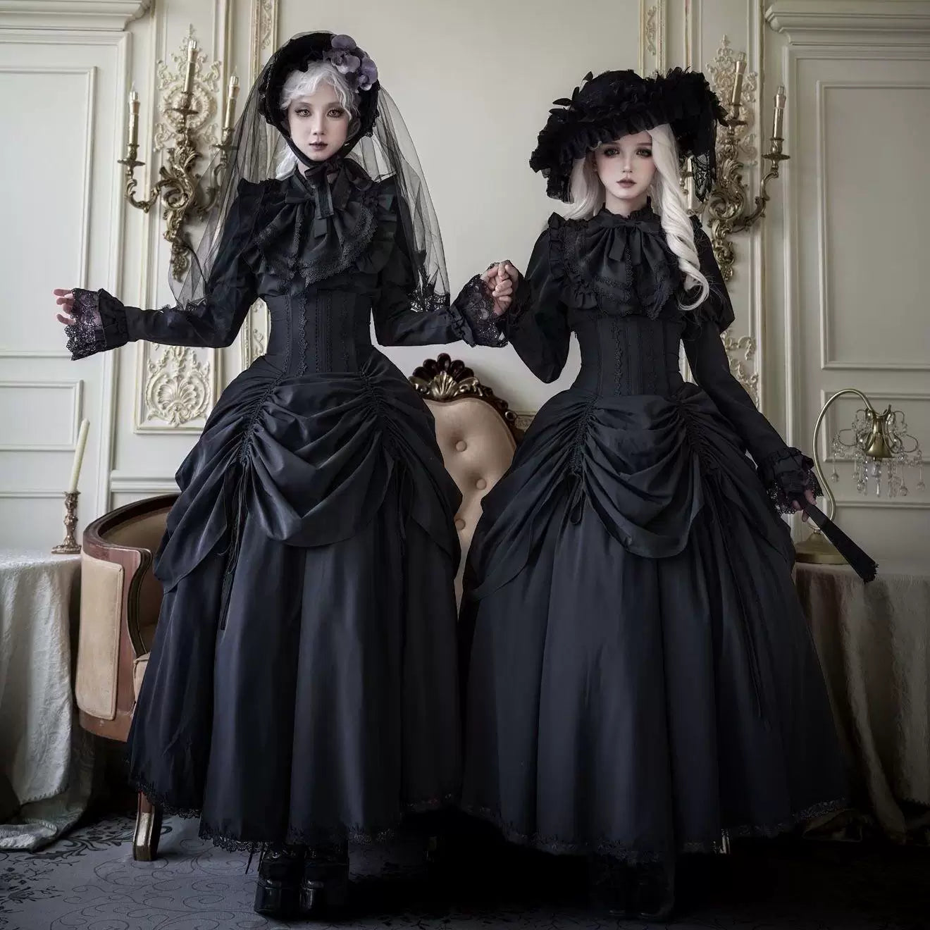 Black dark-gothic Lolita styling with ruffled blouses, corset waists and gathered skirts.