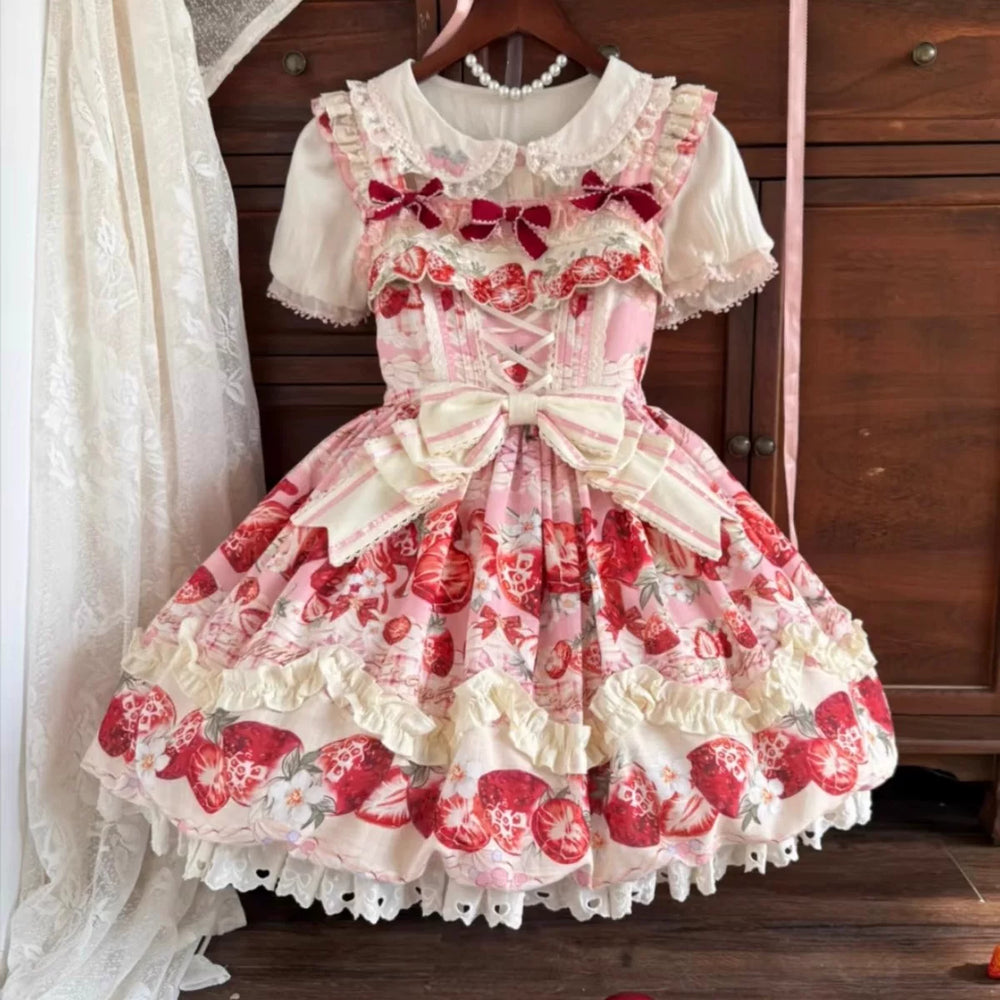 Strawberry-print Lolita jumper skirt with pink bows and tiered ruffles