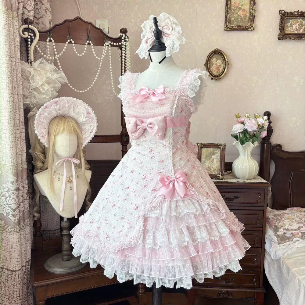 Pink lace Lolita outfit displayed on a mannequin with layered ruffles and bows.