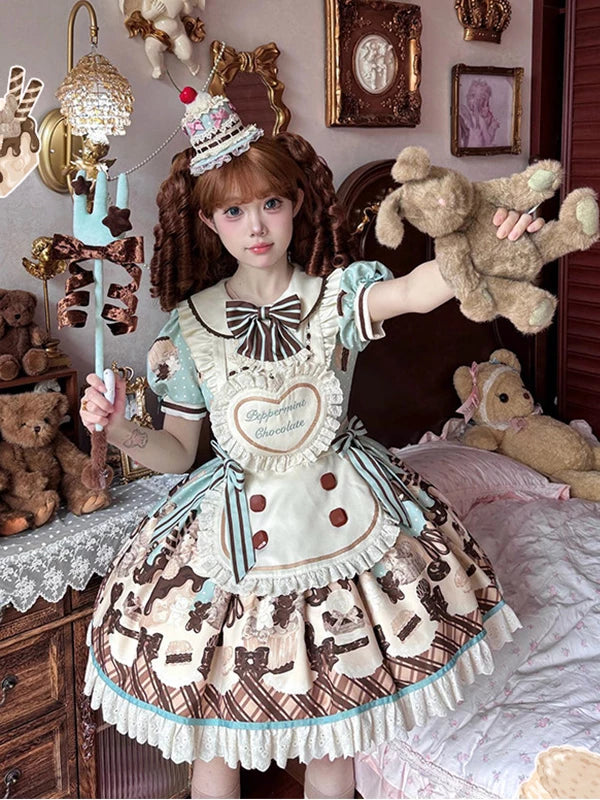 Model wearing a mint-and-cream OP dress set with apron and striped bow