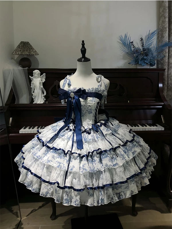 Blue-and-white tiered puppy-print dress displayed on a mannequin before a piano.