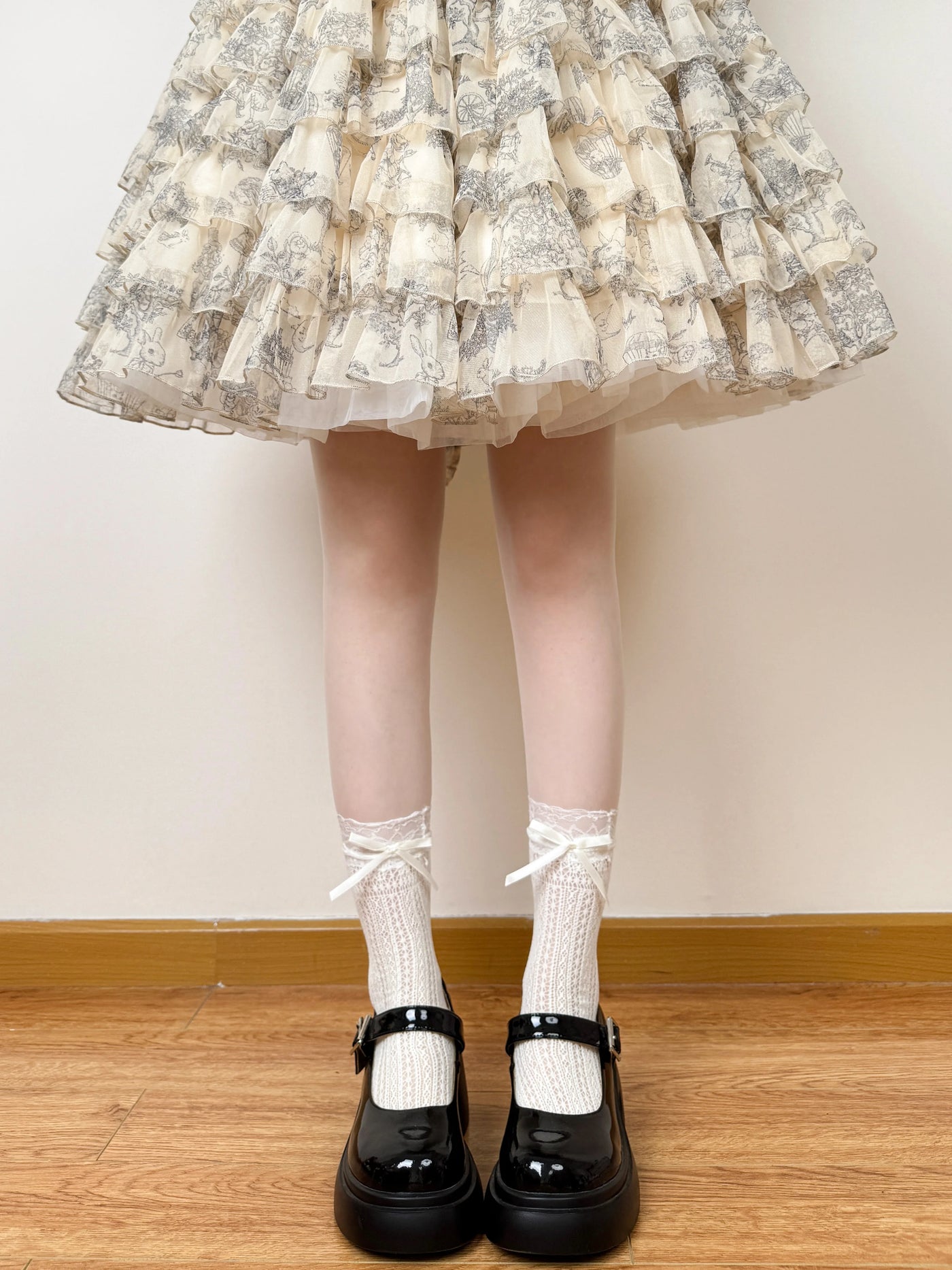 Model-worn lace mid-calf socks with bow detail.
