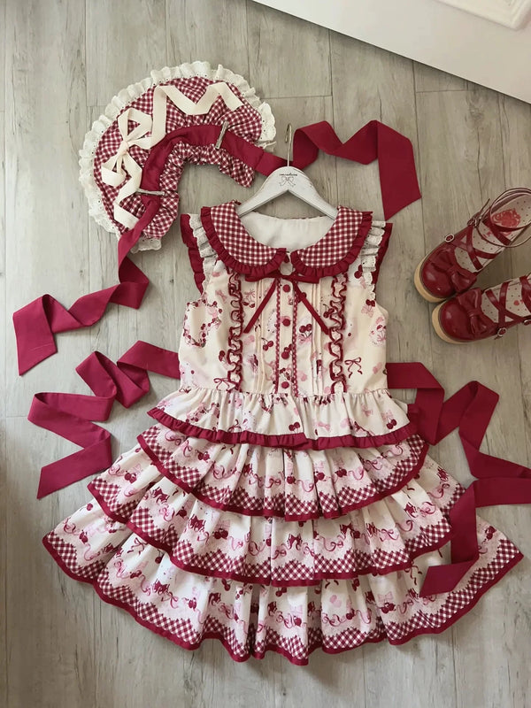 Red and cream three-tier JSK dress with cherry motifs, gingham collar, tiered skirt and burgundy bows.