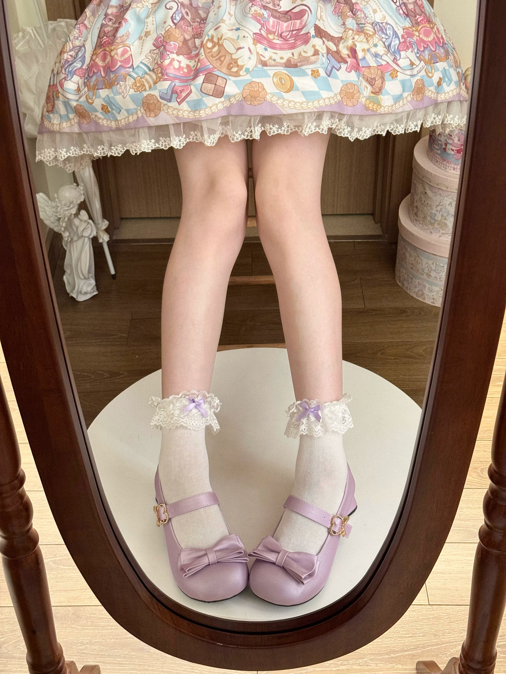 White short socks with lace cuffs and lavender bows styled with lilac Mary Jane shoes