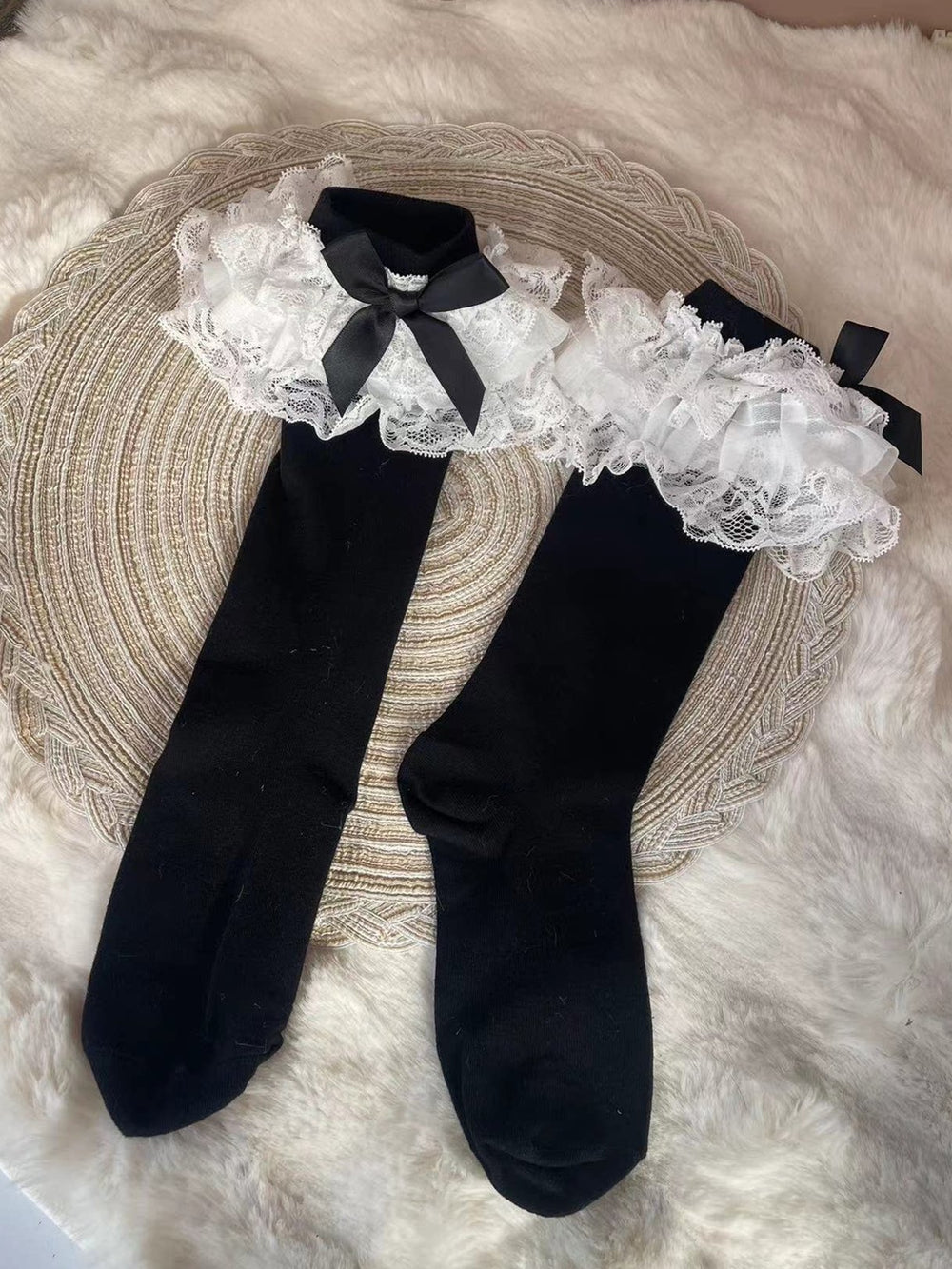 Light blue calf socks with white lace trim and bows worn with platform shoes