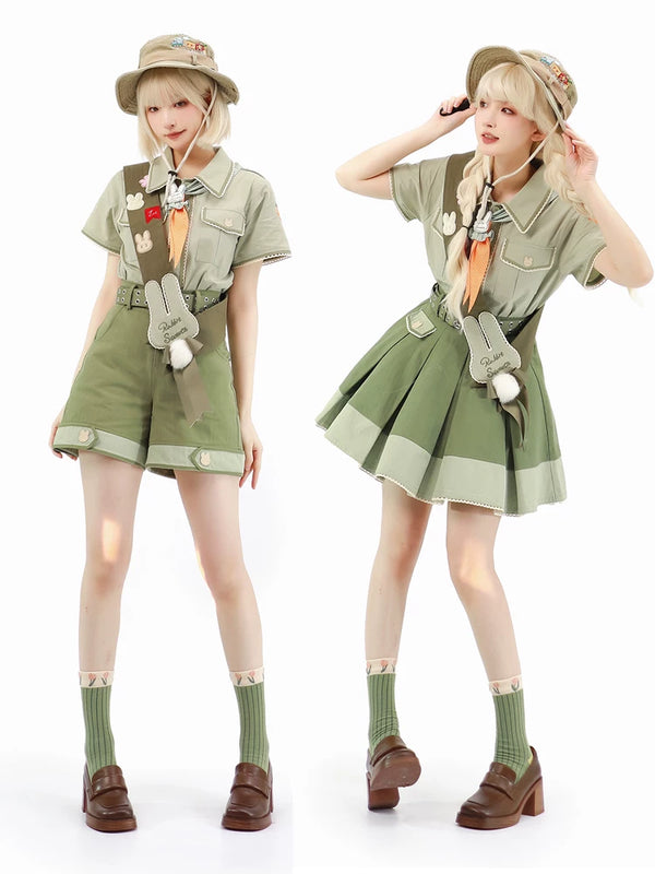 Khaki-green bunny-themed skirt and trouser outfit with neckerchief, belt and pom-pom accents.