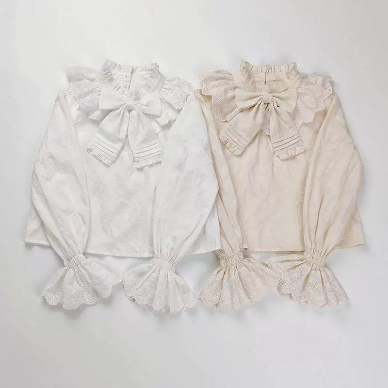 Sweetheart Dream Machine ecru cotton jacquard blouse with a high ruffled neck and centered bow.