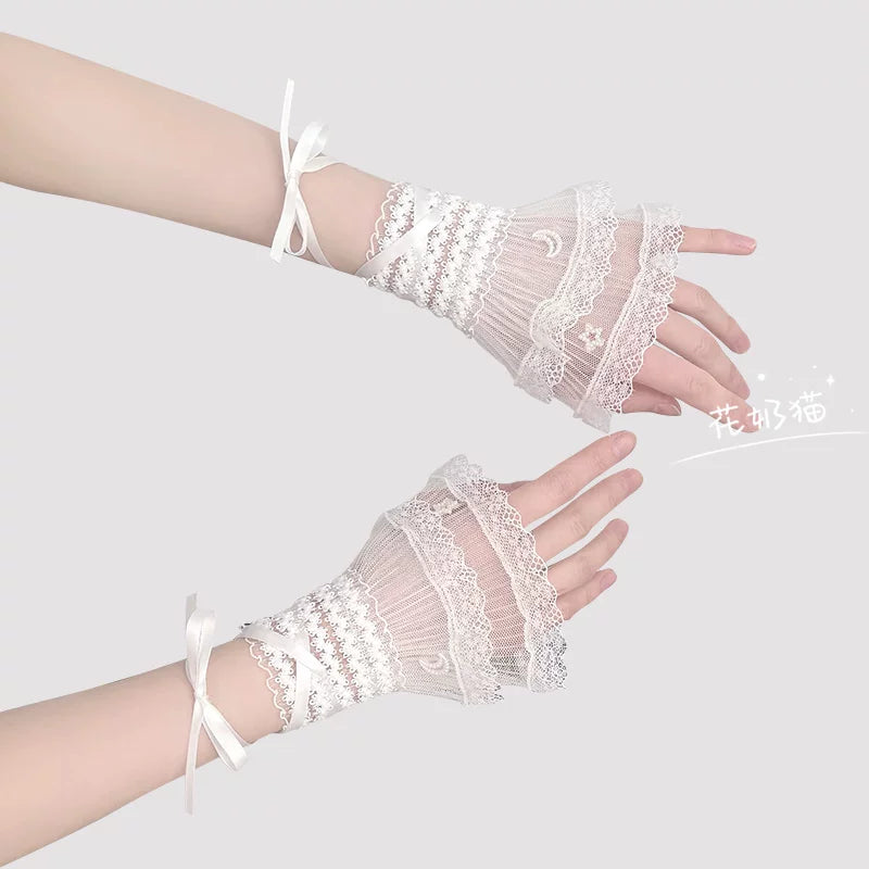 White Lolita lace wrist cuff with star and moon motifs and ribbon tie