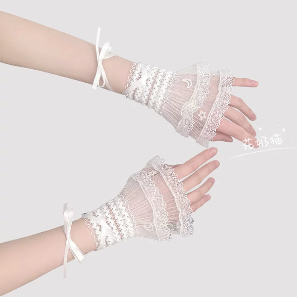 White Lolita lace wrist cuff with star and moon motifs and ribbon tie