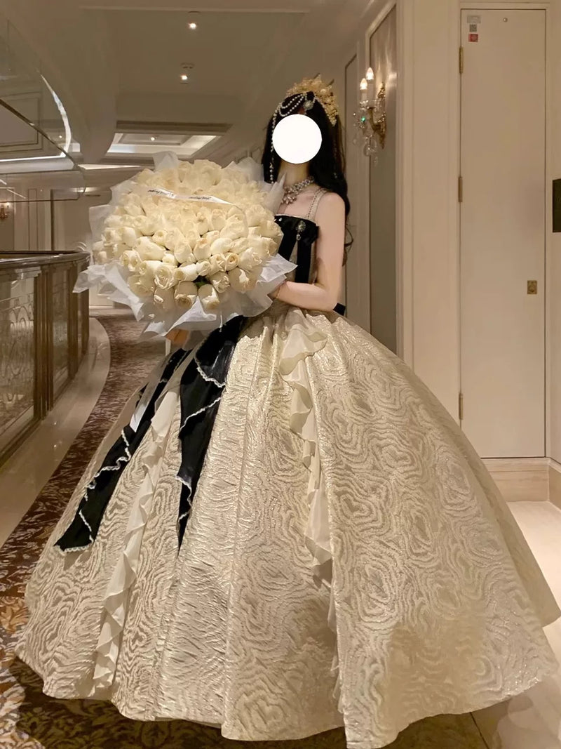 Detail of black satin bow with pearl embellishments on Lolita ballgown bust