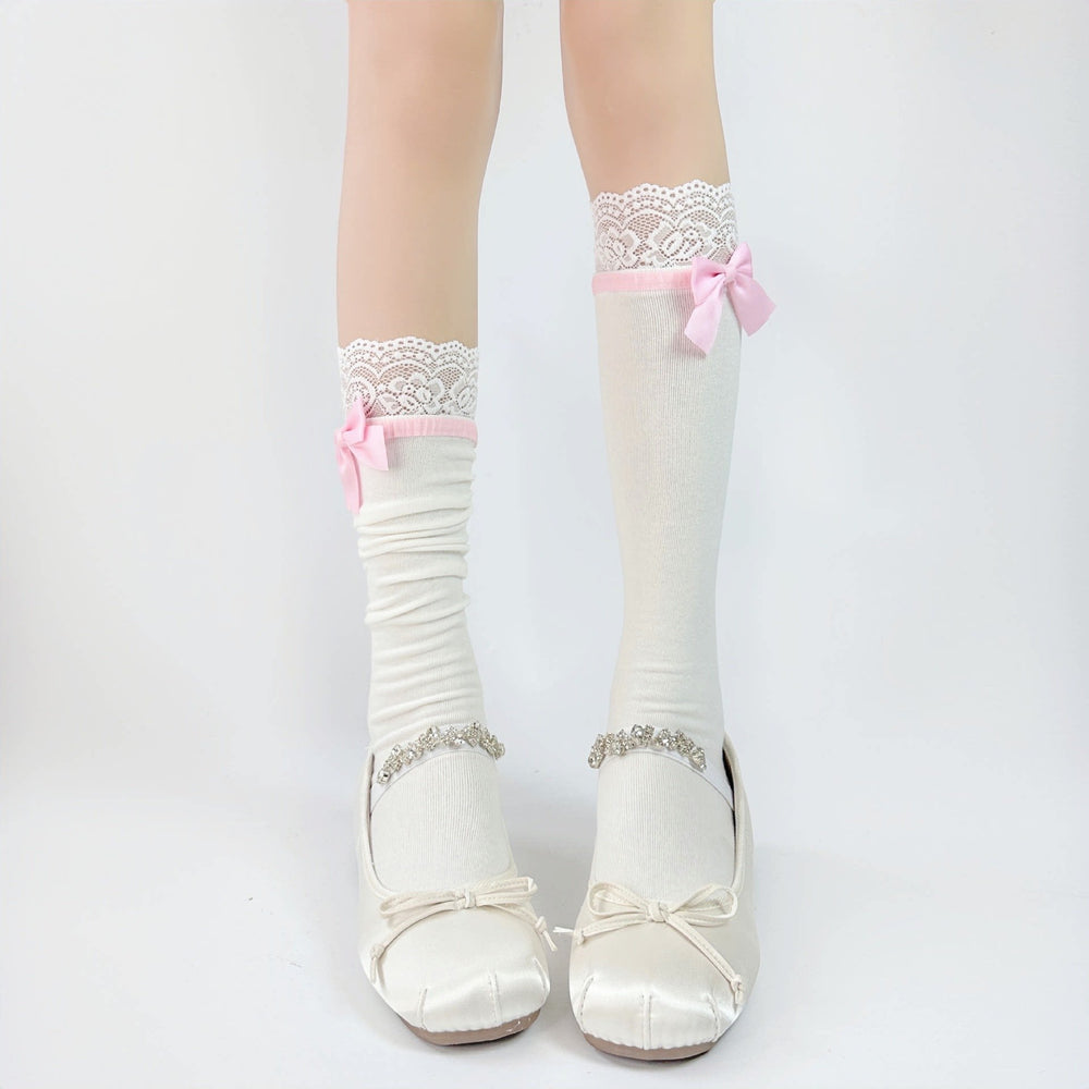 Lace-trimmed white socks with bows styled with Mary Jane shoes.