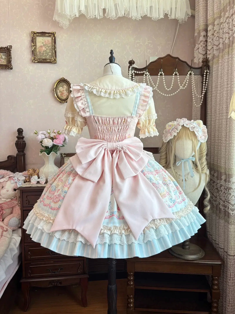 Full view of the dress's tiered bell-shaped skirt with dessert print and lace hem trim