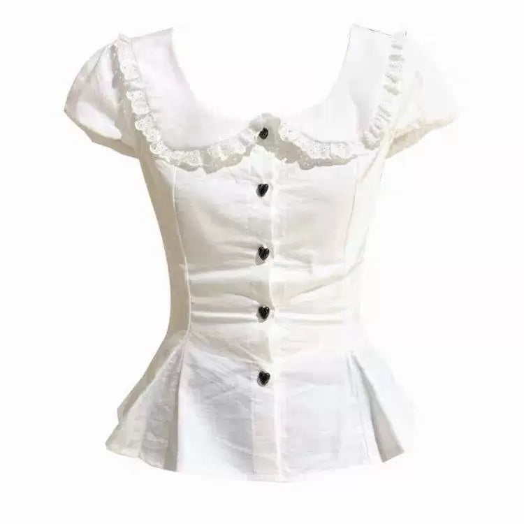 White blouse with a rounded ruffle-edged collar, short puff sleeves and black buttons.