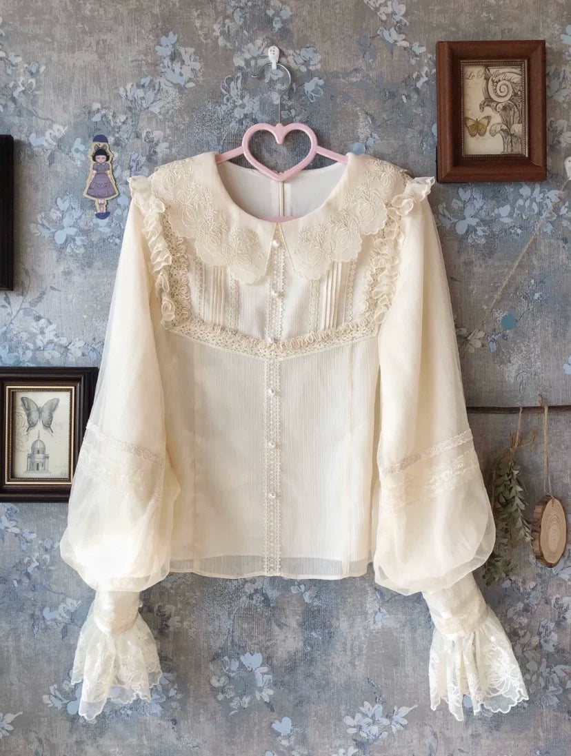 Long-sleeve white Lolita blouse with a floral lace collar on a hanger