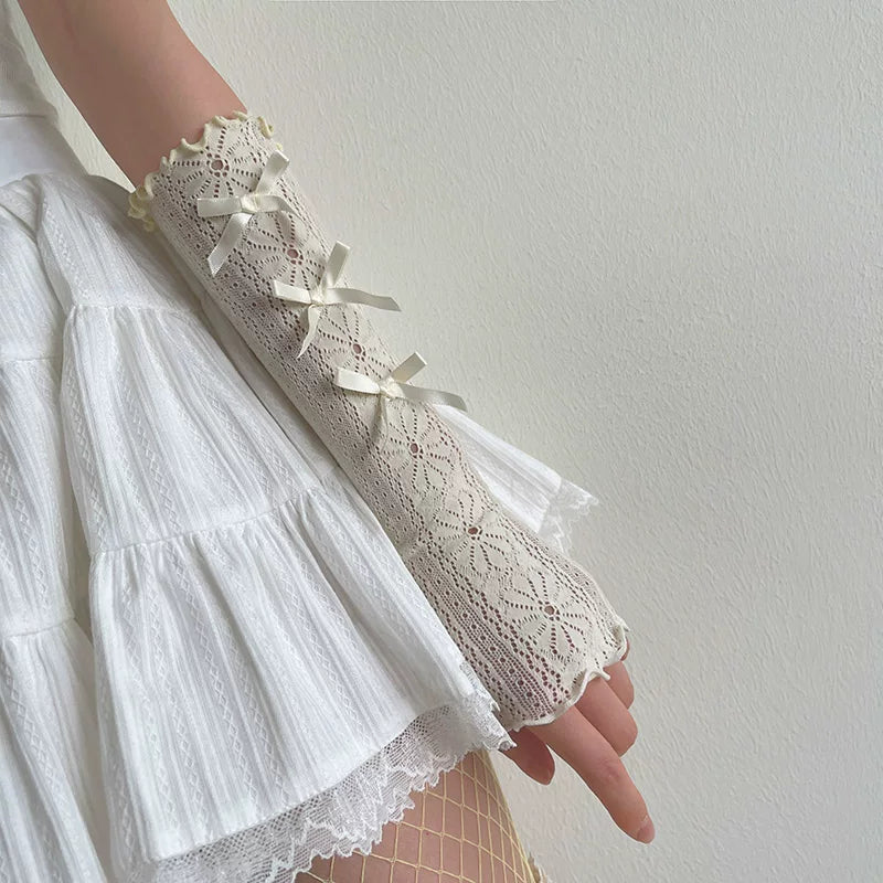 White lace arm sleeve with small ribbon bows and ruffled edging.