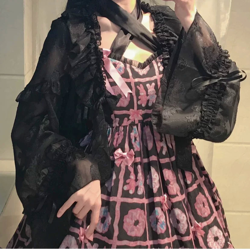 Ruffled chiffon cardigan with lantern sleeves and bow ties shown in black and light colorways.
