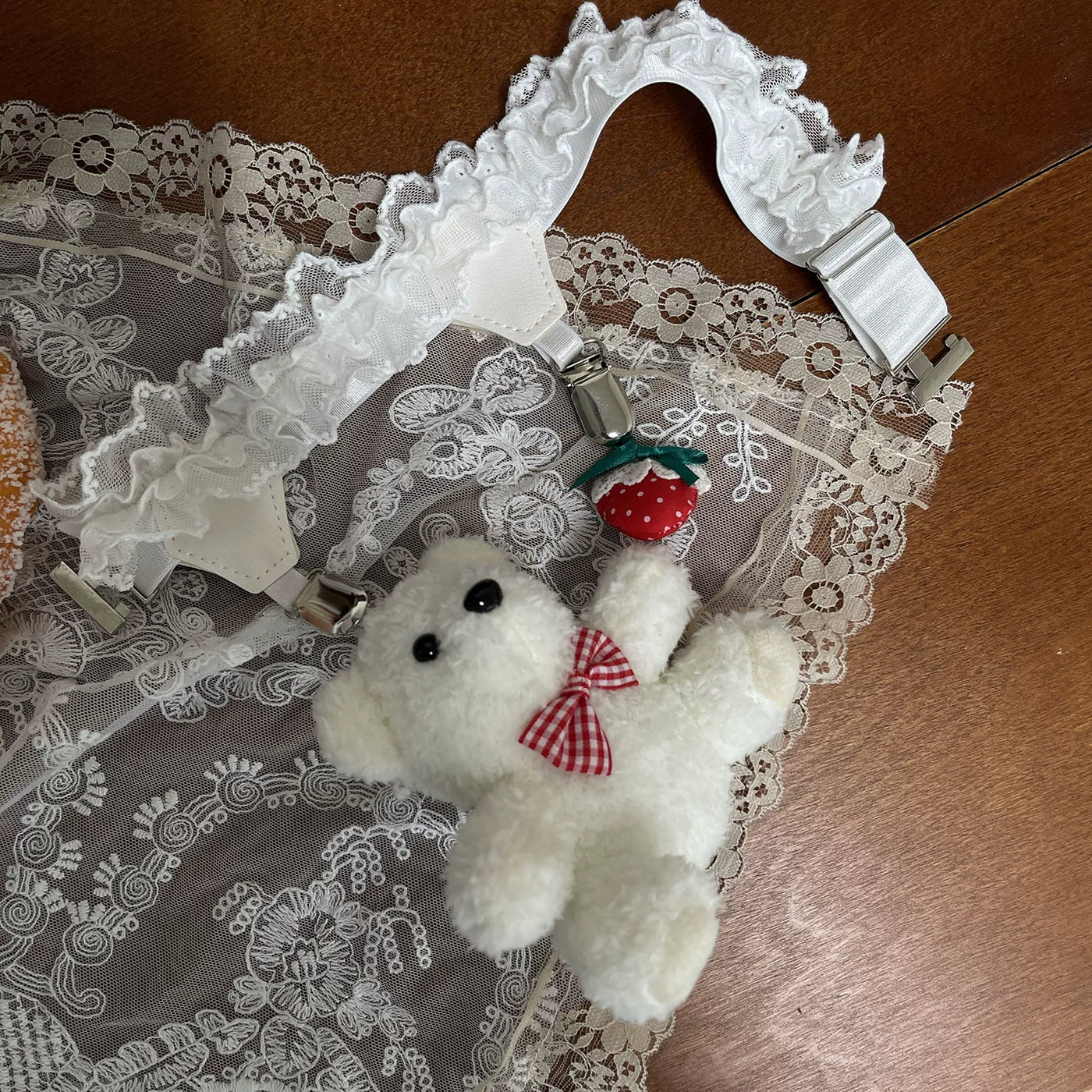 White lace-trim mid-calf socks with red ribbon ties and a teddy-bear leg ring.