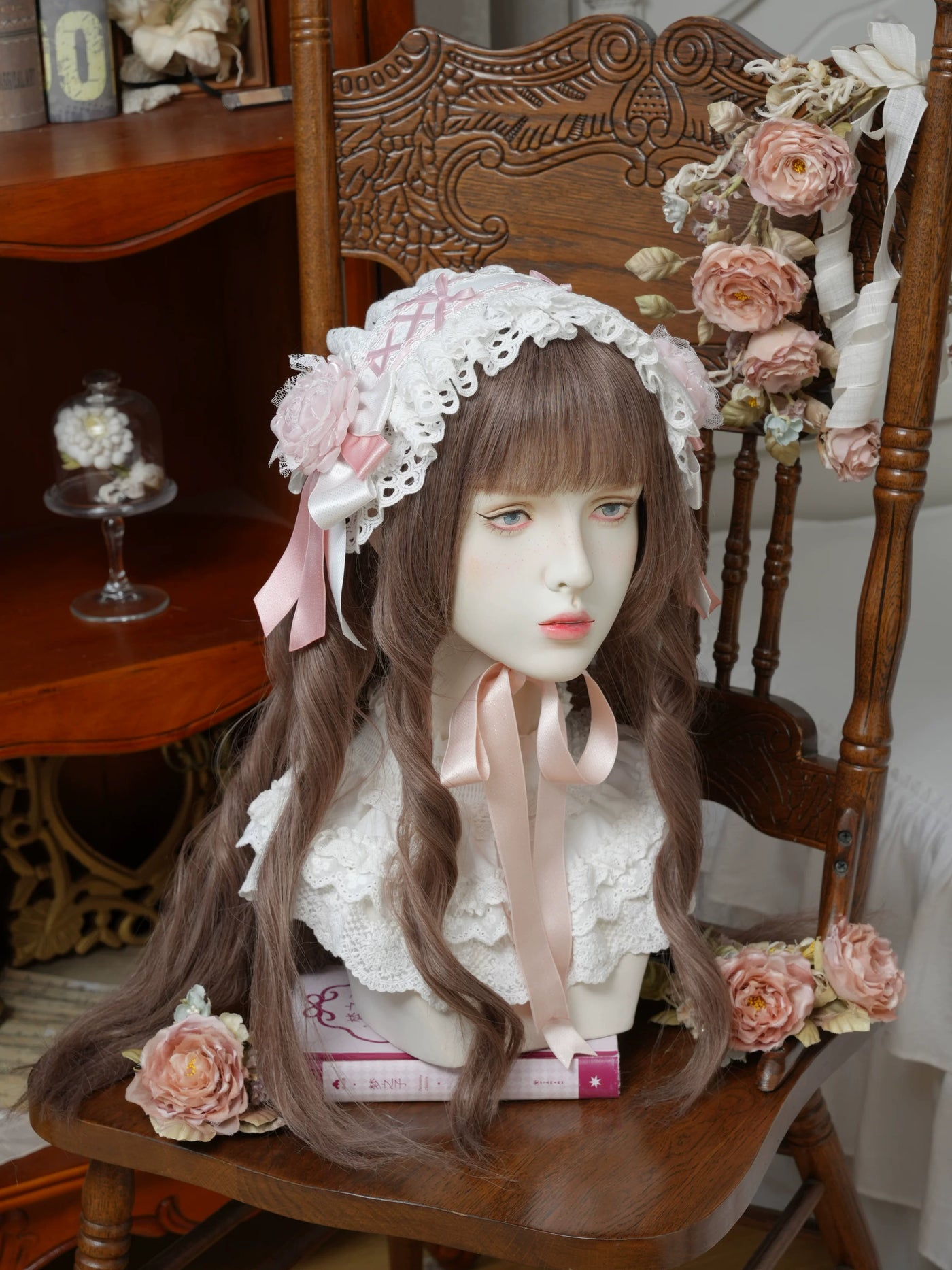 White Star Box headwear with scalloped lace, pink rose and trailing ribbons on a mannequin