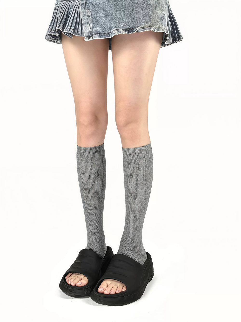 Grey and blue footed slouch leg warmers shown with sandals and closed-toe shoes.